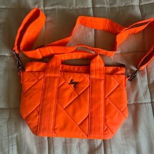 Lug Quilted Crossbody Bag in Bright Orange.